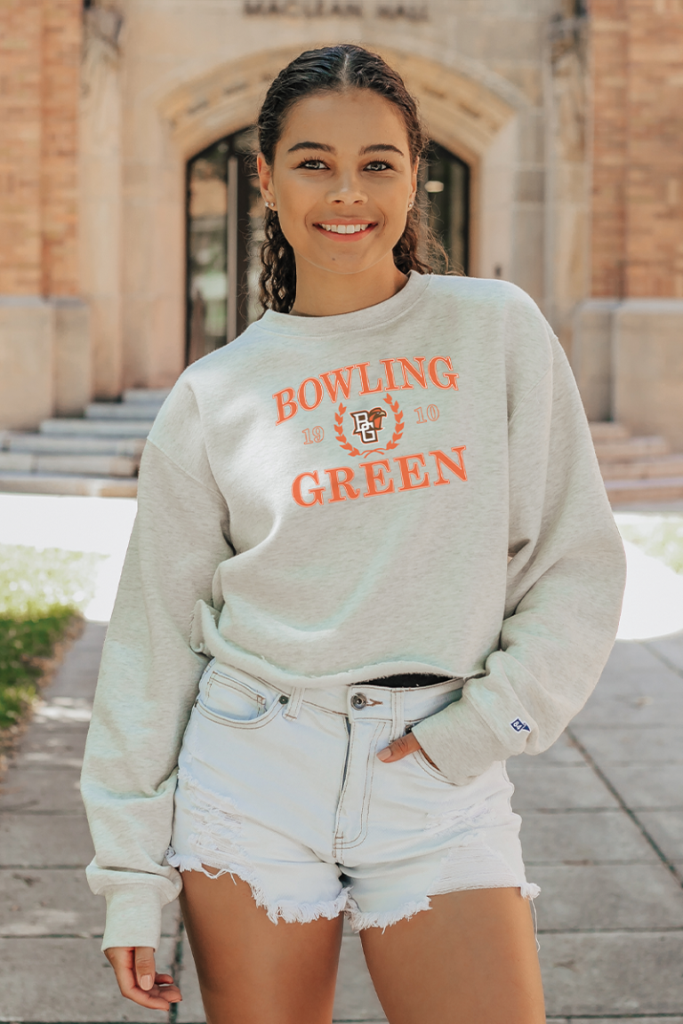 Female model wearing a college Blue 84 crew sweatshirt.